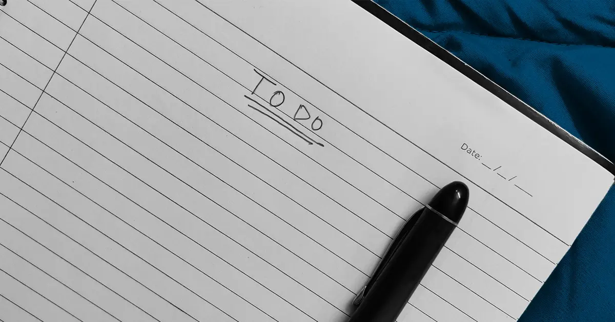 photo of a pen on a lined notebook with a heading that reads "To Do" (featured image: "Year End Payroll Checklist" article)