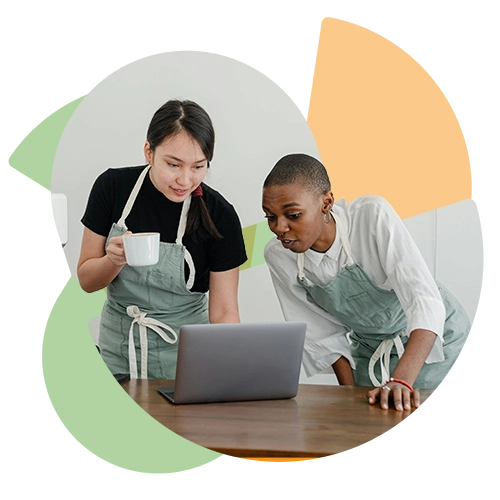 stylized photo of two women in aprons looking at a laptop