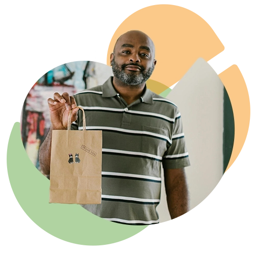 stylized photo of a man holding a customized bag from his purchase at a small business